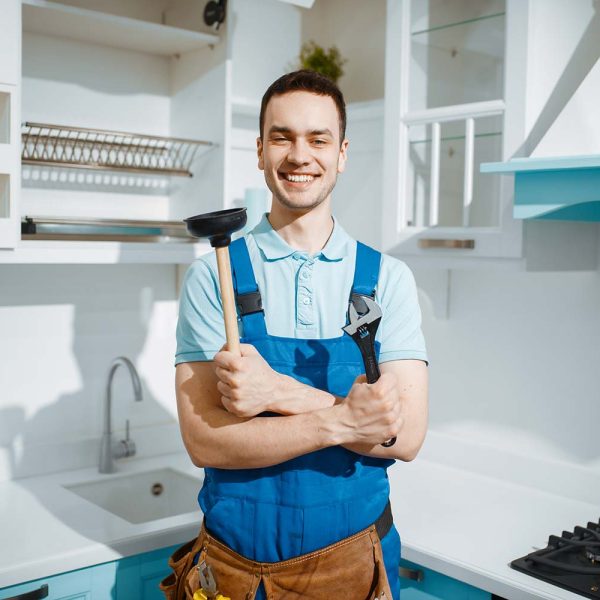 cheerful-male-plumber-holds-wrench-and-plunger-resize.jpg