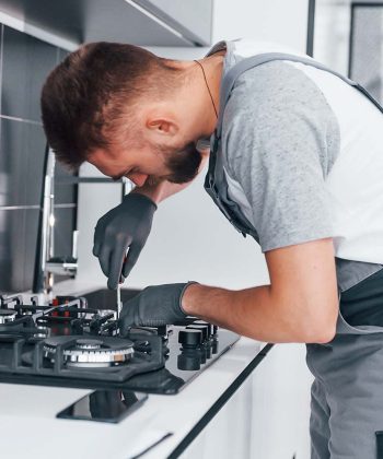 young-professional-plumber-in-grey-uniform-working-resize.jpg